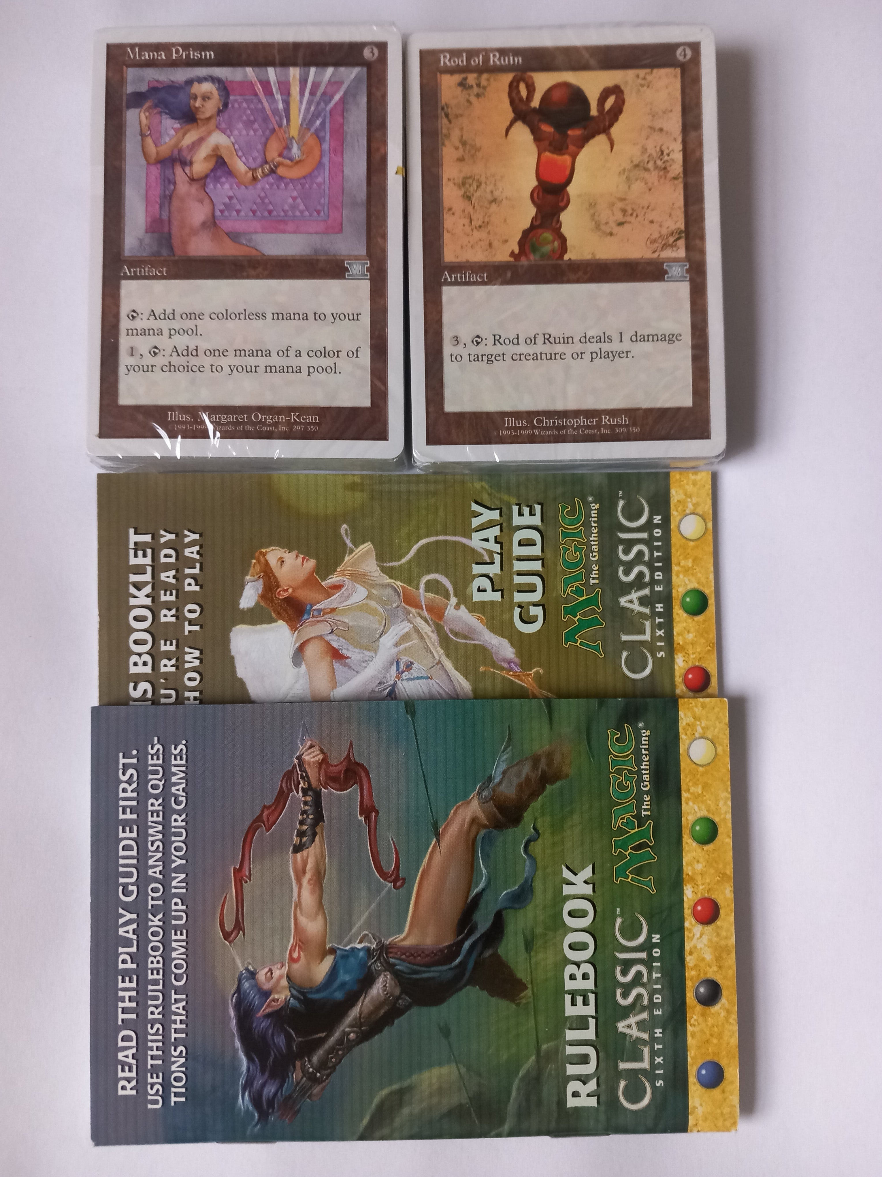 Collection of 'Classic Magic' game materials including a rulebook, play guide, and cards on a white background.